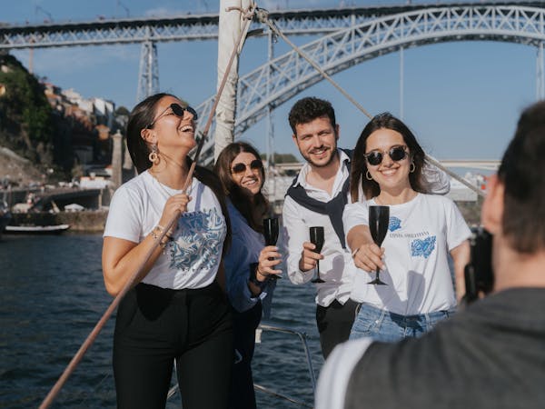 a group of people standing on a bridge over a body of water rio douro sailing 360