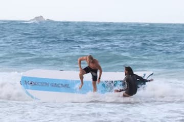 a person riding a wave on a surfboard in the ocean