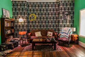 Sherlock Holmes themed London escape rooms. Pictured: Sherlock Holmes living room filled with furniture and a fireplace