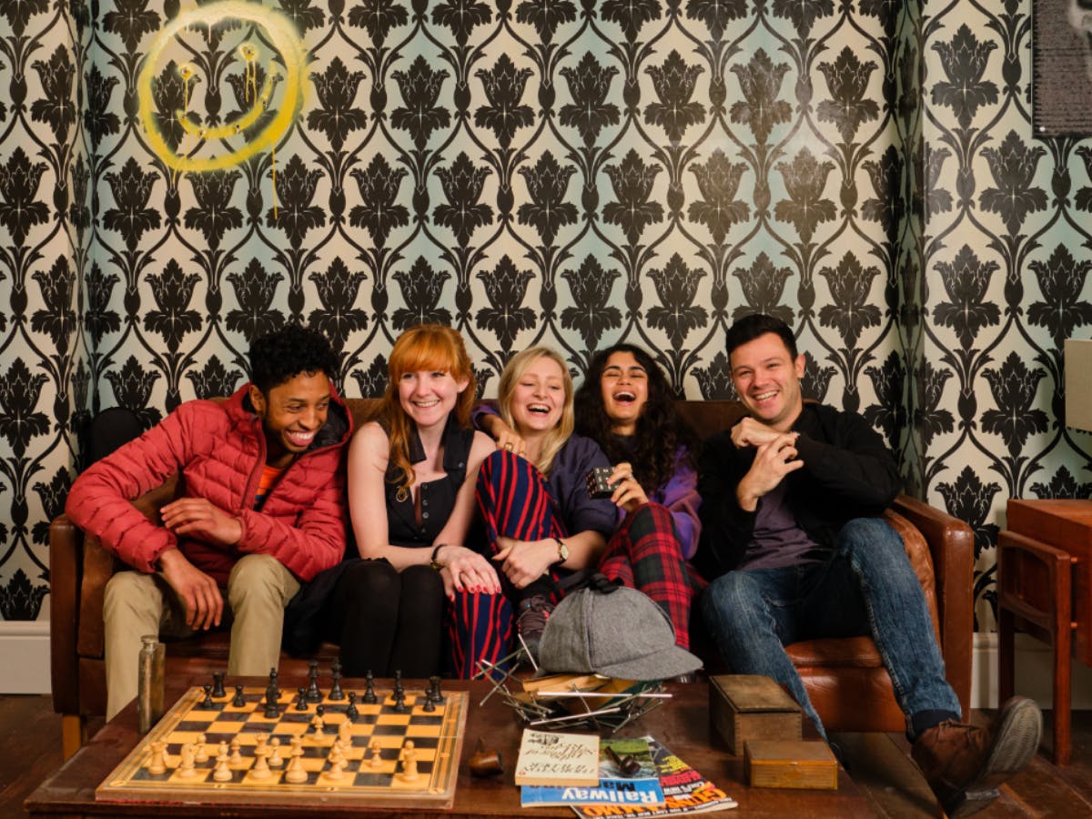 A group of people in 221B during a corporate experience at Sherlock: The Official Live Game, London.