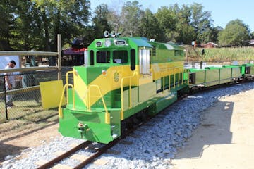 a green train parked at a park