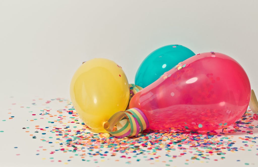A pink, yellow and blue party balloons