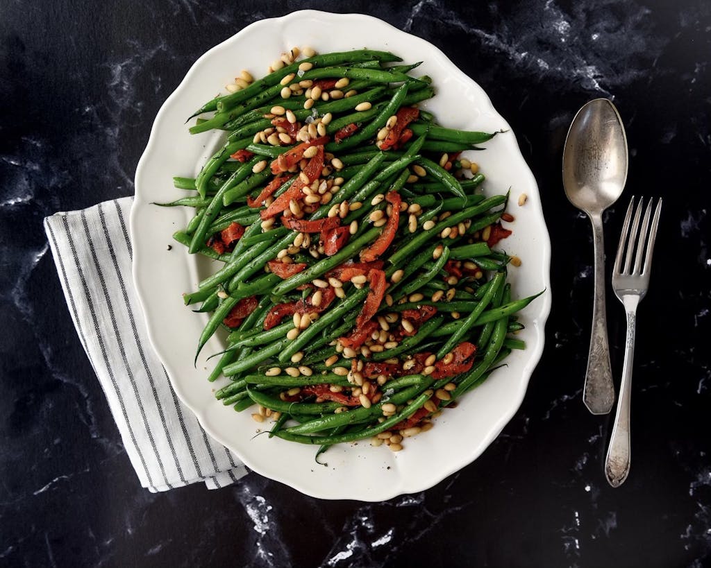 a plate of green beans on a table