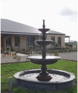 a fountain in front of a house