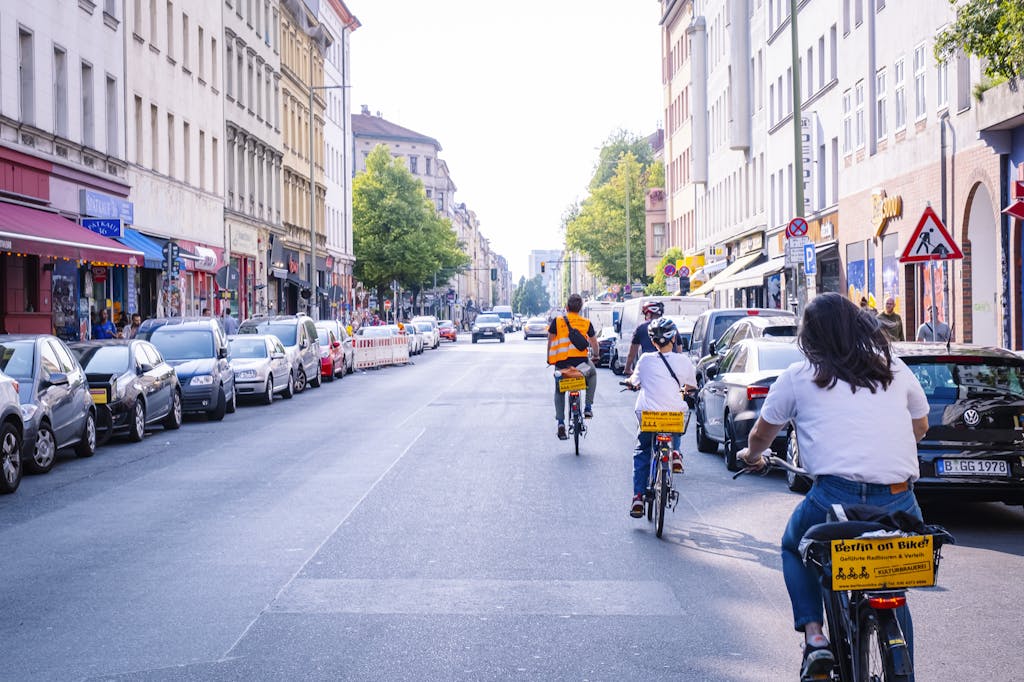 a group of people riding a bike in the Berliner Oranienstrasse