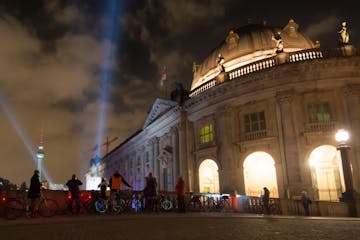 Bike tour in Berlin by night in front of Bode Museum on Museum Island