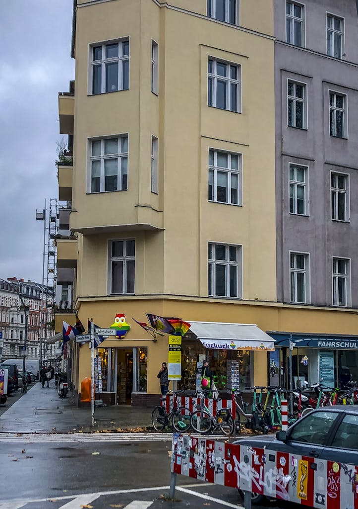 a street corner in the Schöneberg neighbourhood in Berlin with rainbow signs and flags