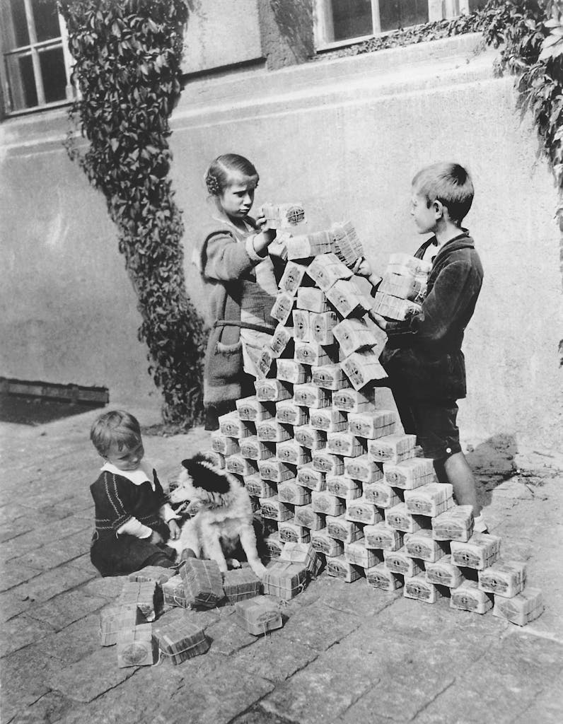 a group of young children playing with with valueless money in Germany in 1923