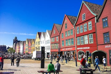 a group of people walking in front of Bryggen