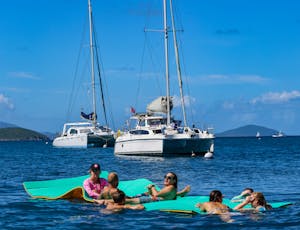Seas the Day Charters USVI Party Yacht Sea Wolf guests hanging out on lily pad