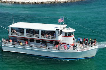 The Southern Star glass bottom boat bringing people on a Destin dolphin cruise