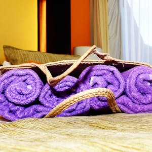 a bed with a purple blanket