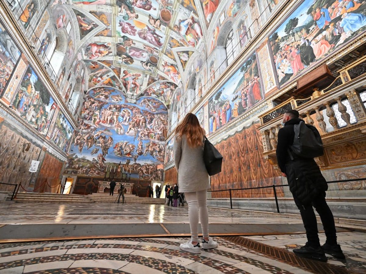 a person standing in front of Sistine Chapel