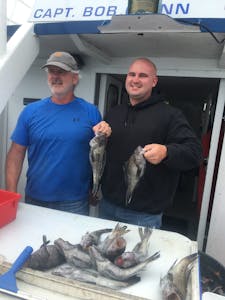 Benoit Groulx et al. standing in front of a fish