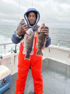 Omar Sy holding a fish in the water