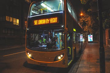 a bus on a city street at night