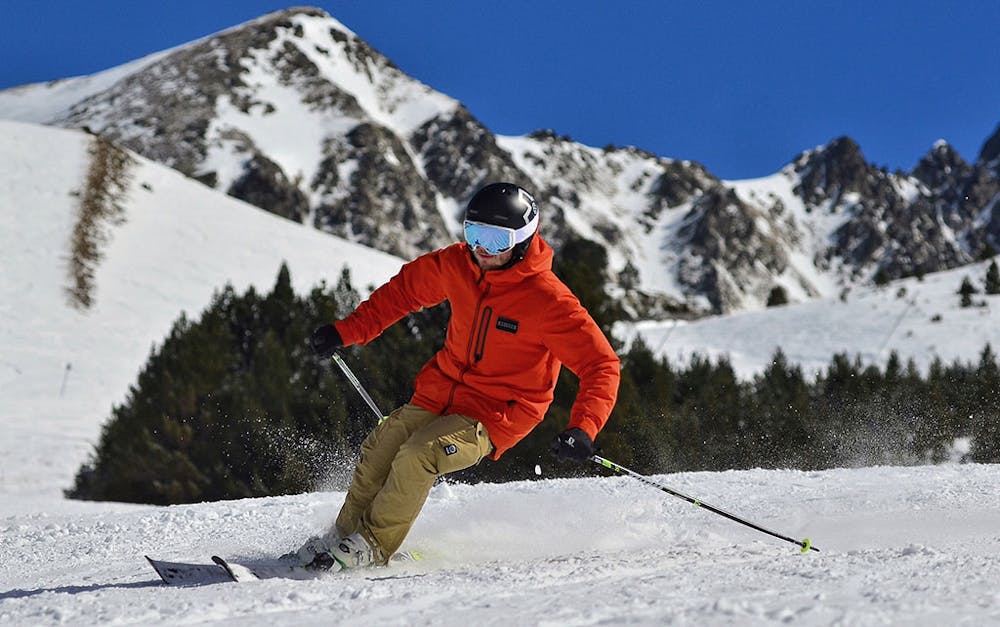 a man skiing down a snow covered slope