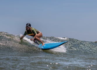 a man riding a wave on top of a body of water