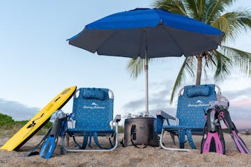 a group of lawn chairs sitting on a chair with a blue umbrella