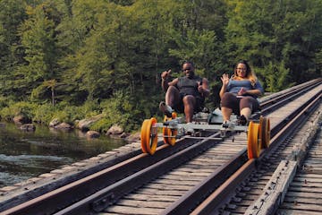 a group of people sitting on a train track