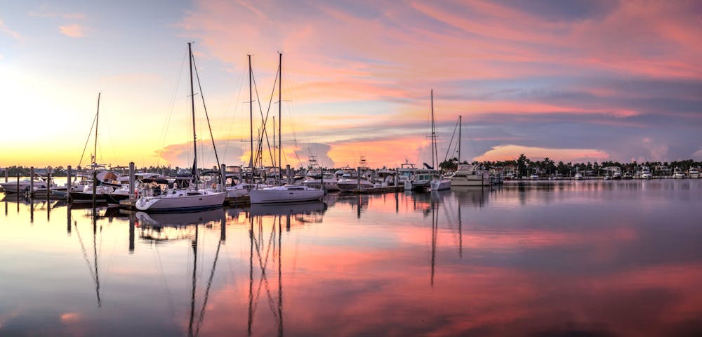 Sunrise over a quiet harbor in old Naples, Florida during the summer