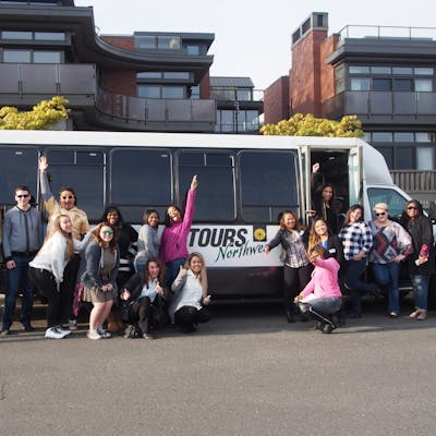 people posing in front of the Tours Northwest bus on Premier Seattle City Tour