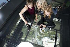 happy people taking a photo through a glass floor