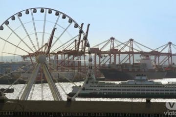 a large ferry on the water and a ferris wheel