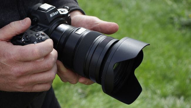 a close up of a person holding a camera