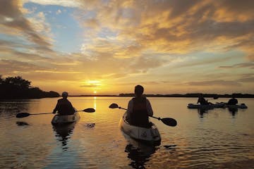 people on kayaks at sunset in the Indian River Cocoa Beach