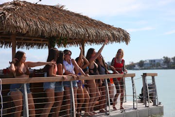 people looking out over the deck of a tiki boat