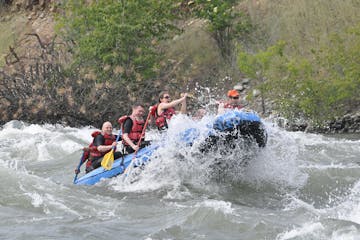a group of people riding on a raft in a body of water
