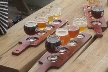 a group of beer glasses on a wooden table