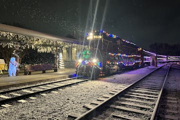 Decorative holiday lights illuminating the Tennessee Valley Railroad Museum in Chattanooga, creating a festive atmosphere for visitors.