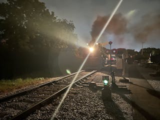 a train on a track with smoke coming out of it