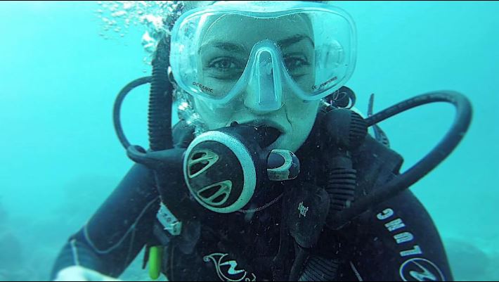 Female scuba diver taking selfie underwater