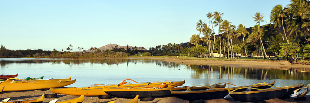 A row of parked boats on the sandy beach of Maunalua Bay