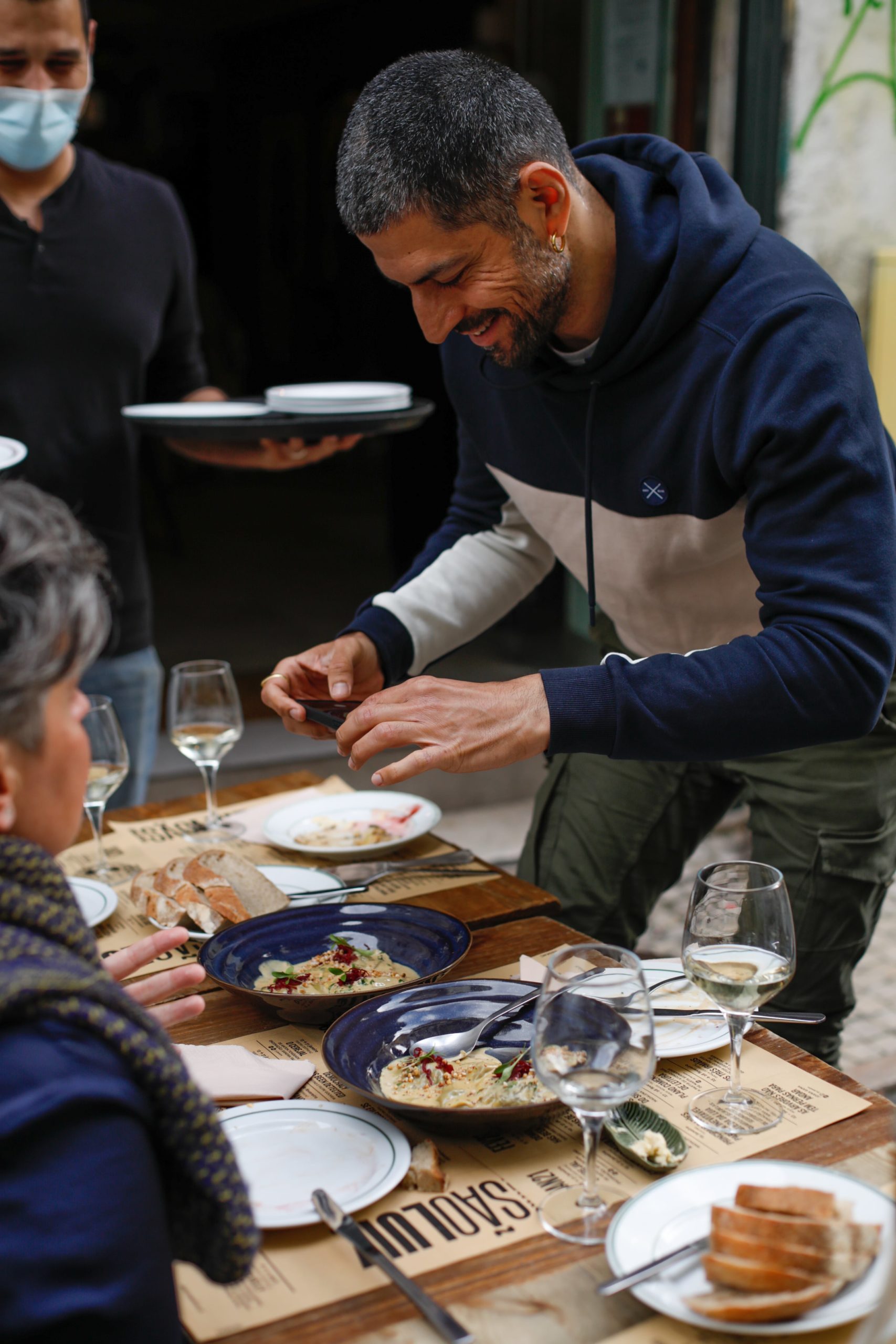 a group of people sitting at a table with food