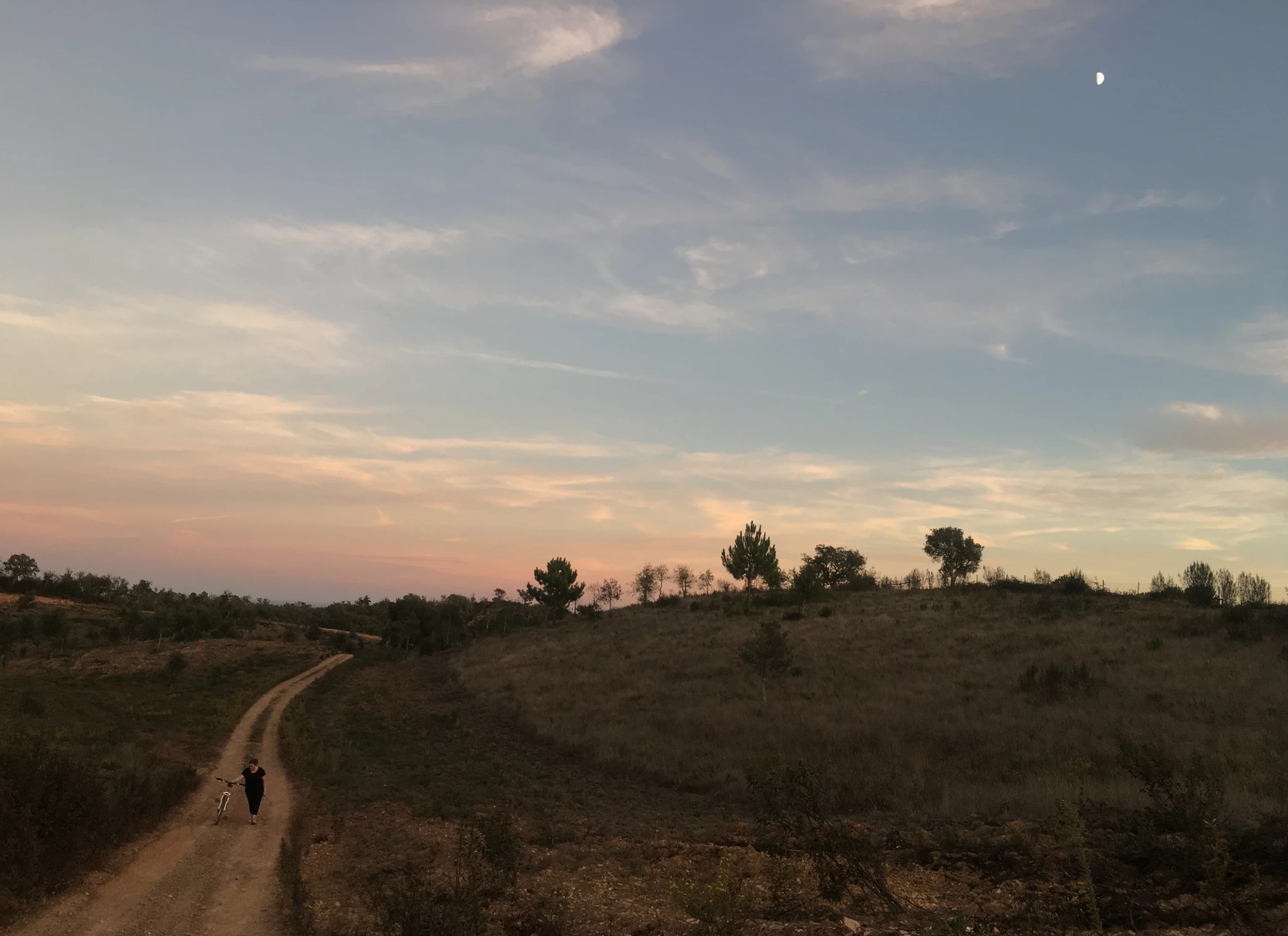 a sunset over a grass field