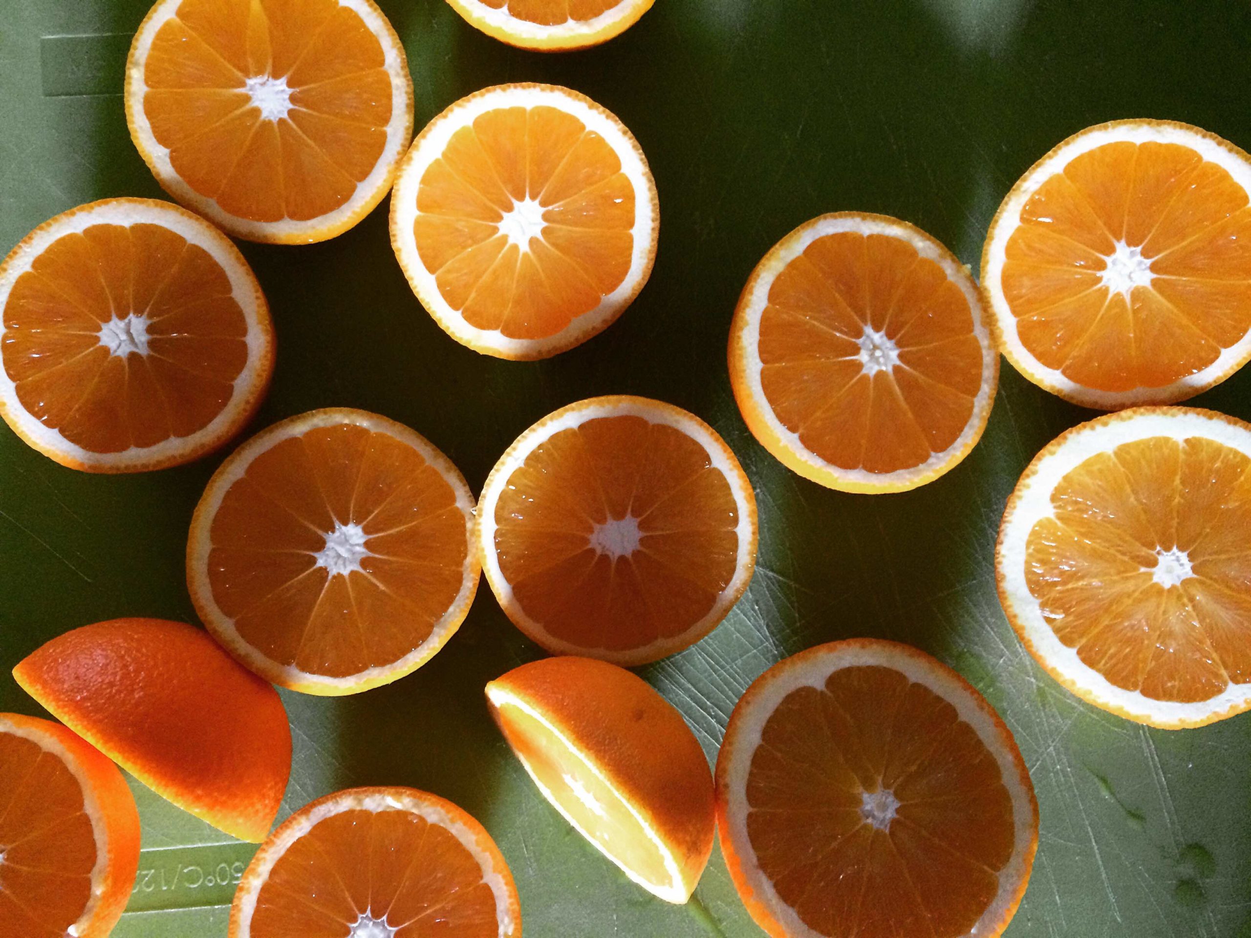 a group of oranges cut in half