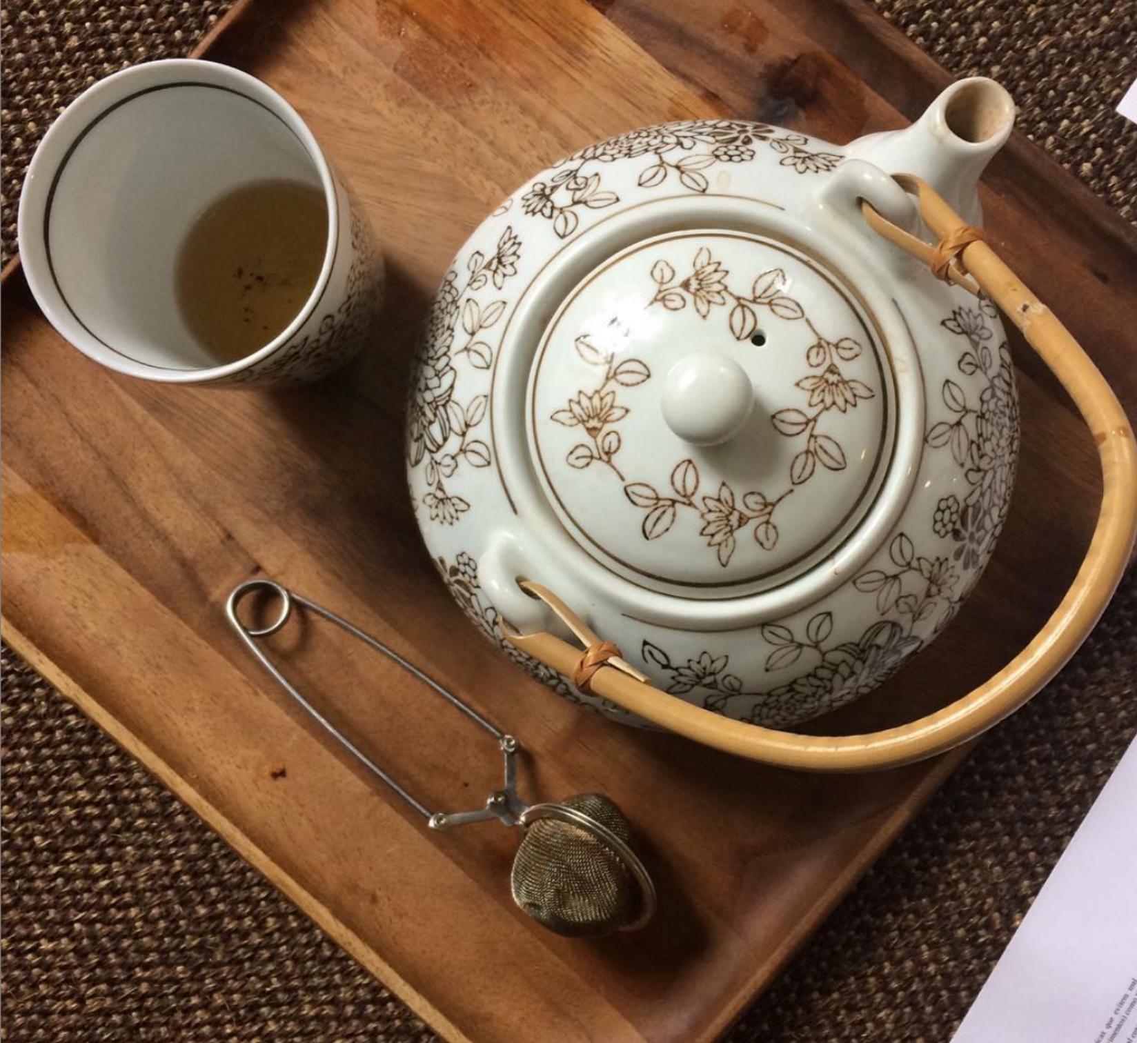 a cup of coffee sitting on top of a wooden table