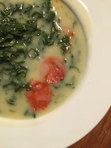 a bowl of portuguese kale soup
