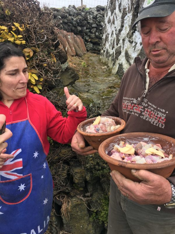 a man grabbing two dishes full of seasoned beaf