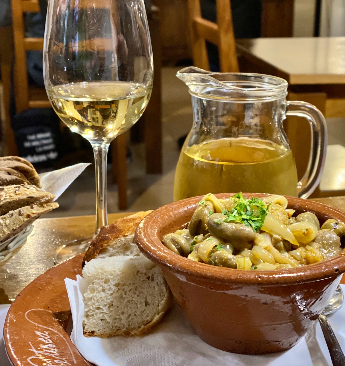 a close up of a plate of food and a glass of wine