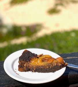 a piece of cake on a plate in front of a beach