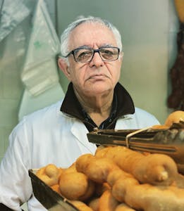 a man selling tripas in Porto