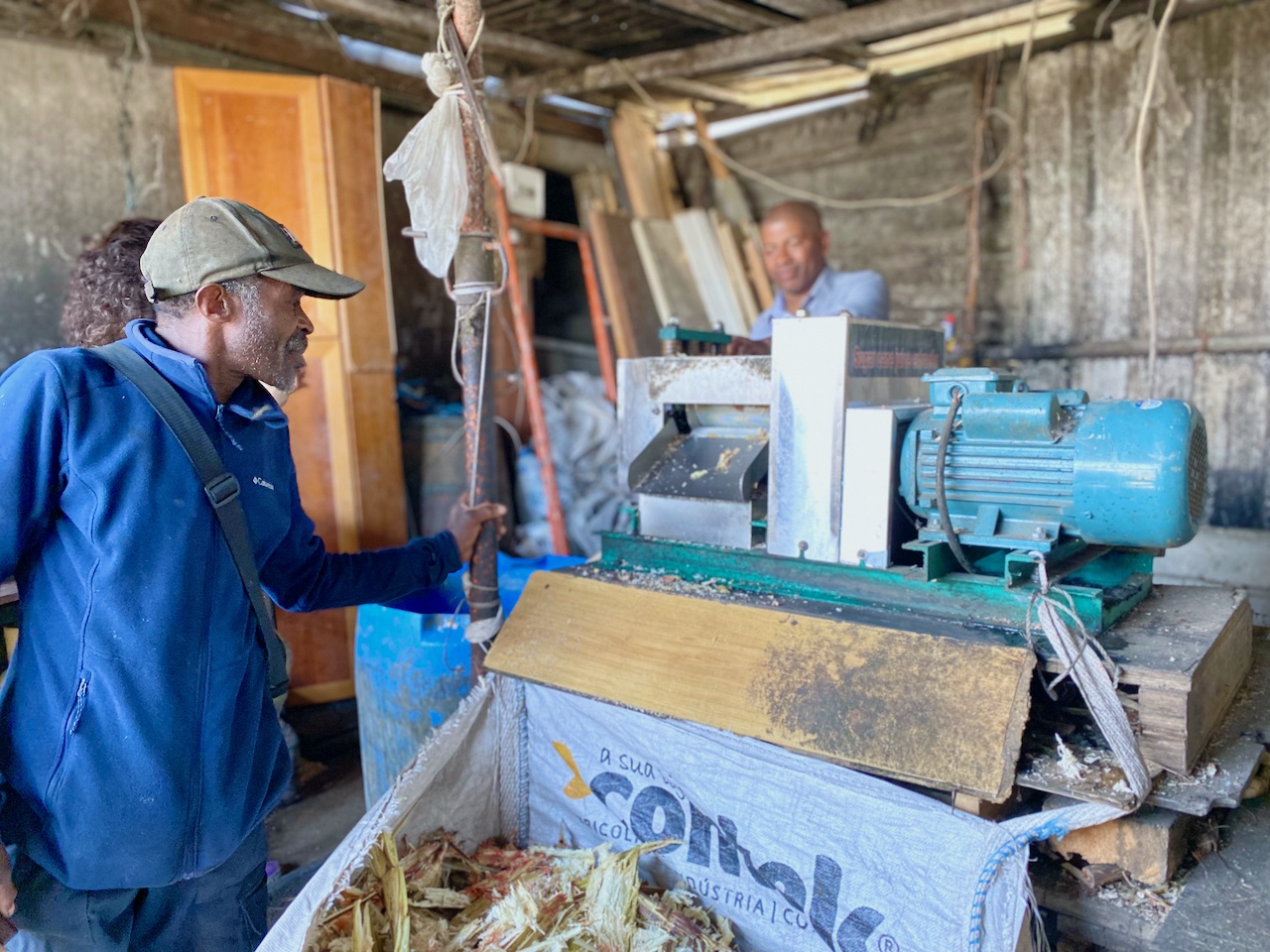 two men around a sugar cane machine in Lisbon