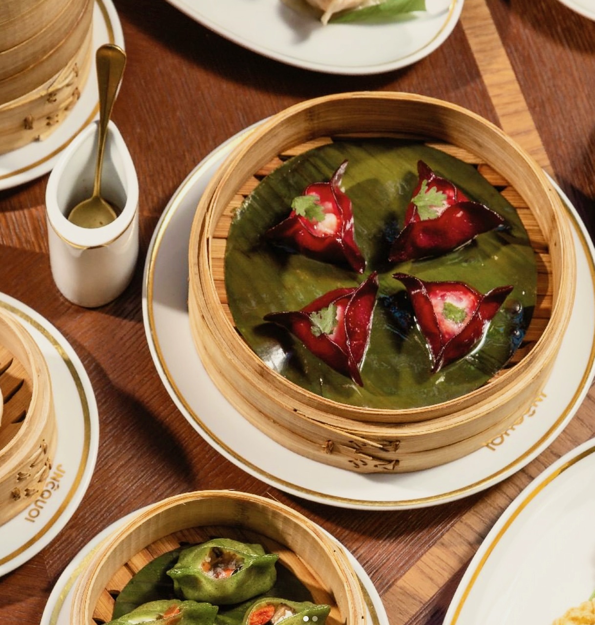 a wooden table topped with plates of food on a plate