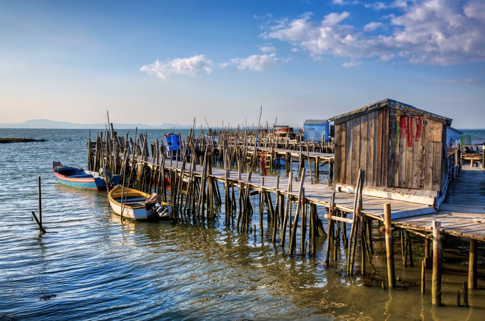 a boat is docked next to a body of water