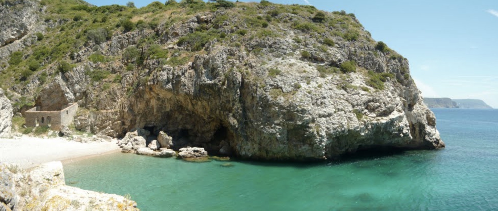 a rocky island in the middle of a body of water